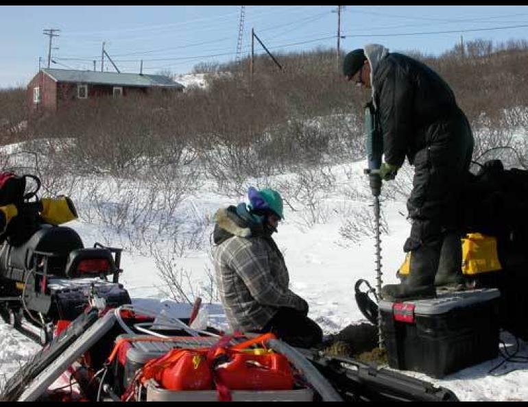 Kenji Yoshikawa and Tohru Saito drill a borehole to monitor permafrost near the village of Golovin. Photo by Ned Rozell.