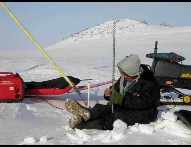  Kenji Yoshikawa drills a hole to monitor permafrost in the Seward Peninsula village of Wales. Photo by Ned Rozell. 