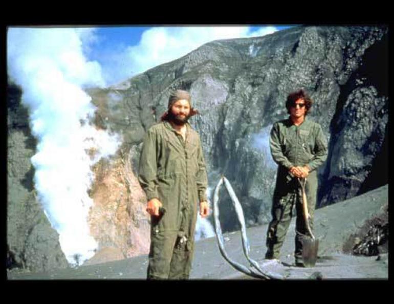  AVO’s John Paskievitch and John Power at the remains of a seismic station on Mount Spurr, the nearest active volcano to Anchorage. The late June 1992 eruption from Crater Peak blasted 44 million cubic meters of ash, blocks, and gas into the atmosphere. Bill Bolling photo, courtesy of Alaska Volcano Observatory. 