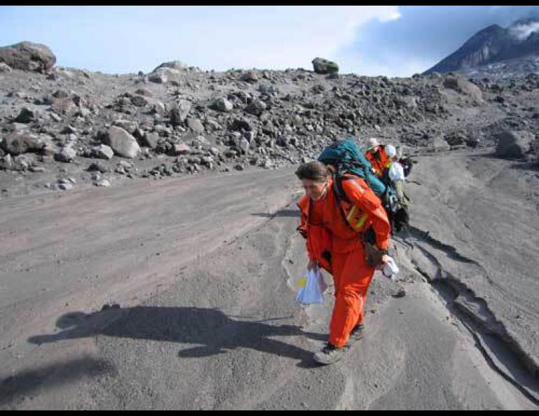  Jess Larsen and Mariah Tilman of the Alaska Volcano Observatory approach a helicopter with rock samples from the Augustine Volcano eruption in 2006. Michelle Coombs photo, courtesy of Alaska Volcano Observatory. 