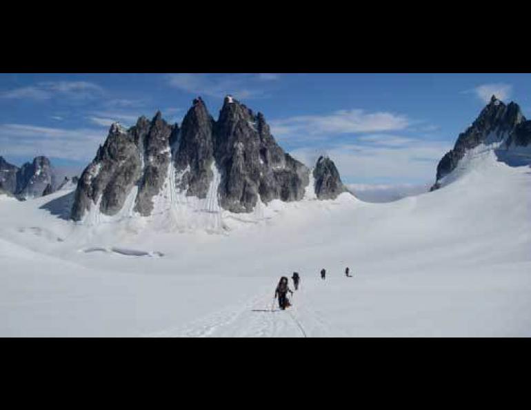 Ice-worm-seeking hikers walk up Pika Glacier in the Alaska Range. Photo by Roman Dial.