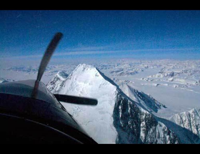 Paul Claus flies over the summit of Mt. St. Elias in his turbine Otter in 2008 as Chris Larsen measures its elevation. Photo by Chris Larsen.