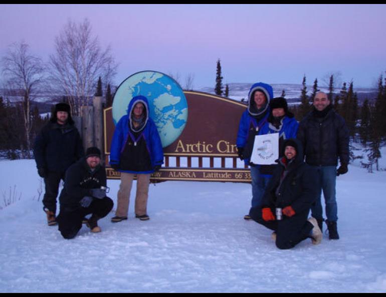  (From left) Ryan West, Shawn Freitas, John Whittington, Doug Morrow, Bernie Tao, Darrin Marshall, and Andy Soria pose at the Arctic Circle pull-out on the Dalton Highway. The group camped there in March and tested the cold-weather performance of “Permaflo Biodiesel.” Photo courtesy Darrin Marshall. 