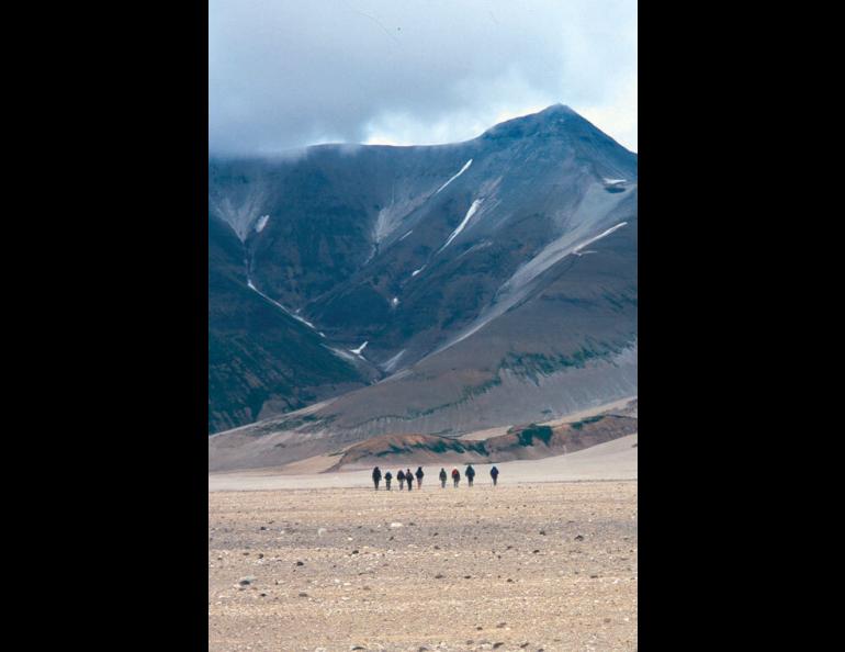 Hikers traverse the Valley of Ten Thousand Smokes on the Alaska Peninsula, walking on a sheet of ash and volcanic rock more than 500-feet-thick. Photo by Ned Rozell.