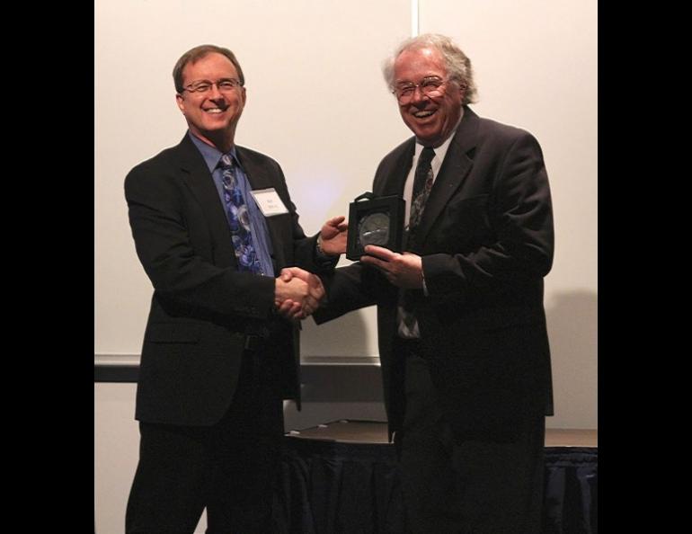 Neal Brown accepts the Roger Smith Lifetime Achievement award in 2016 from Geophysical Institute director Bob McCoy. Geophysical Institute photo.