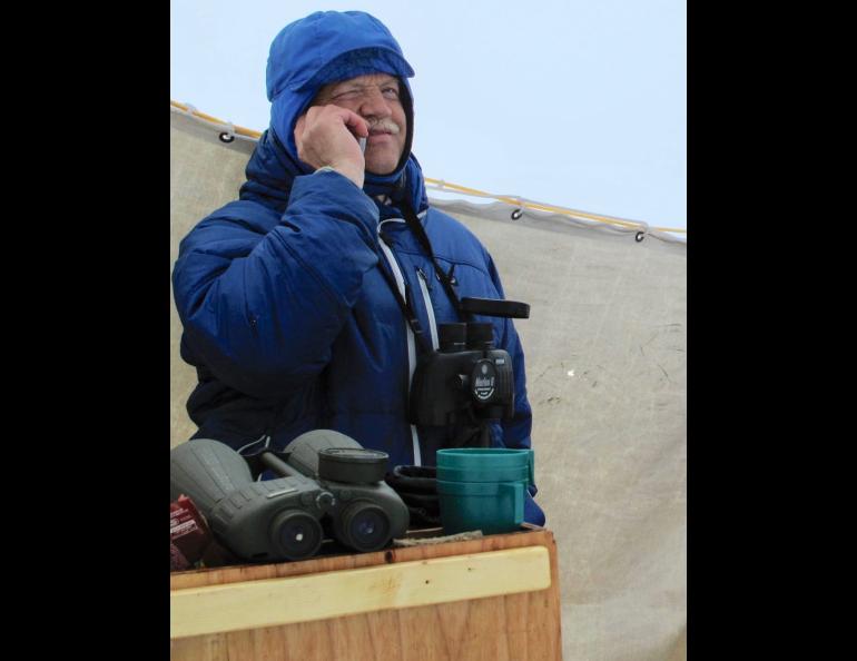 Craig George talks on a cellphone with his wife Cyd Hanns while he takes a break from glassing for migrating bowhead whales north of Utqiagvik in May 2010. Photo by Ned Rozell.