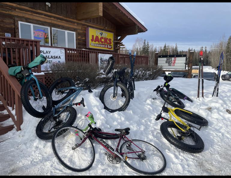 Fat bikes and one non fat bike rest outside Ivory Jack’s bar and restaurant in the Goldstream Valley outside Fairbanks. Photo by Ned Rozell.