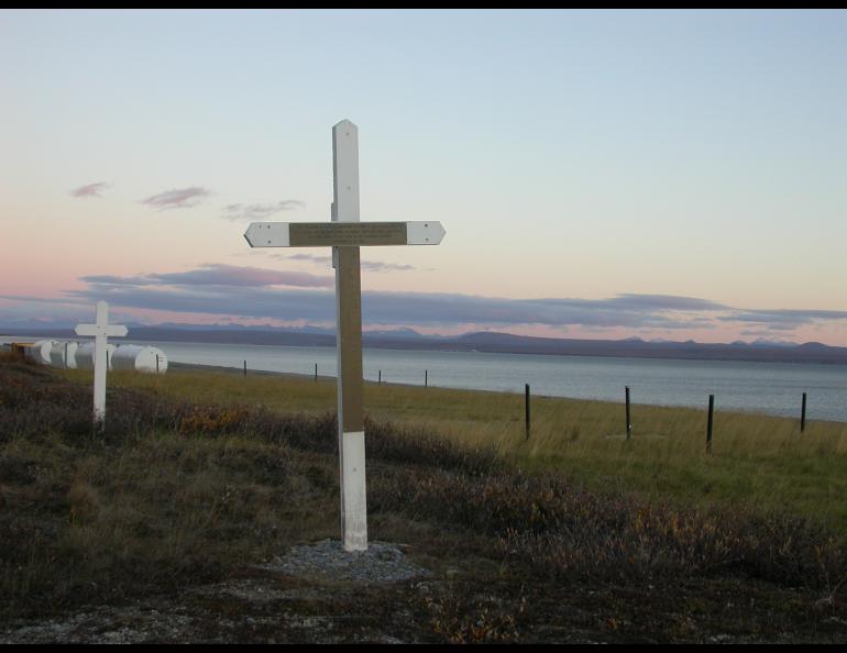 A cross marks a mass grave dug by miners for the bodies of 72 people who died at Brevig Mission in 1918. Photo by Ned Rozell.