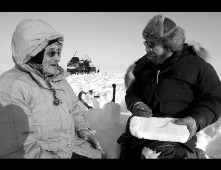  Snow scientist Matthew Sturm, right, speaks with Arnold Brower Sr. outside Barrow. Photo by Craig George. 