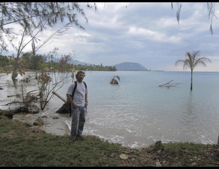 Geologist Rich Koehler stands on a shoreline in Haiti. Landslides during the magnitude 7.0 earthquake in January 2010 transported a few trees out to sea. Photo by Paul Mann.