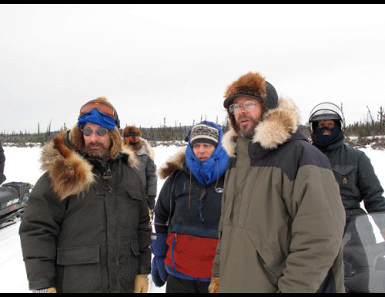  From left, in foreground, Matthew Sturm, Bill Schneider, Knut Kielland, and Sam Demientieff look at possible paths through a slough with unsafe ice. Photo by Ned Rozell