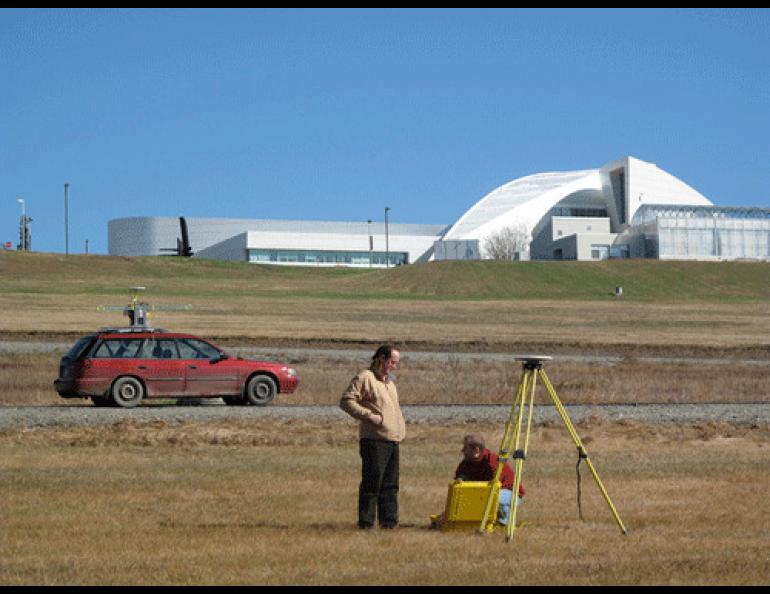 Geophysical Institute researchers Chris Larsen, left, and Austin Johnson, set up a stationary GPS station on the UAF campus to help them verify the data of a mobile GPS/laser system they will use to measure glaciers. Photo by Ned Rozell