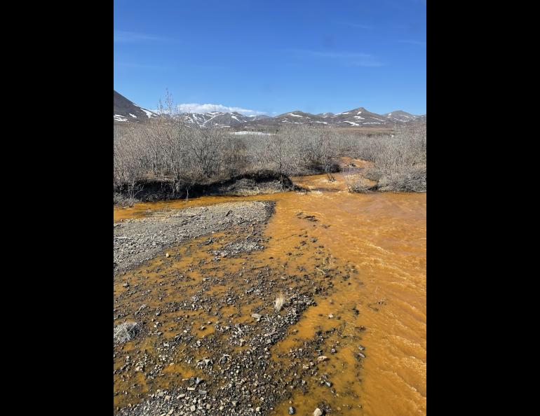 Josh Koch took this photo of the Kugororuk River in northern Alaska in June 2023. The orange stream color reflects oxidized iron, but also often indicates elevated heavy metal concentrations. Photo by Josh Koch.