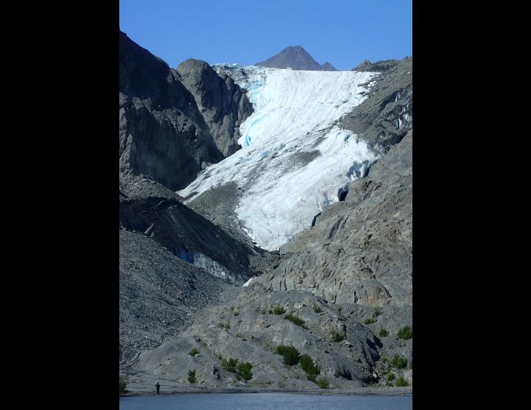 A visitor stands on the shore of a lake near Worthington Glacier, which is accessible by the Richardson Highway not far from Valdez. Photo by Ned Rozell.