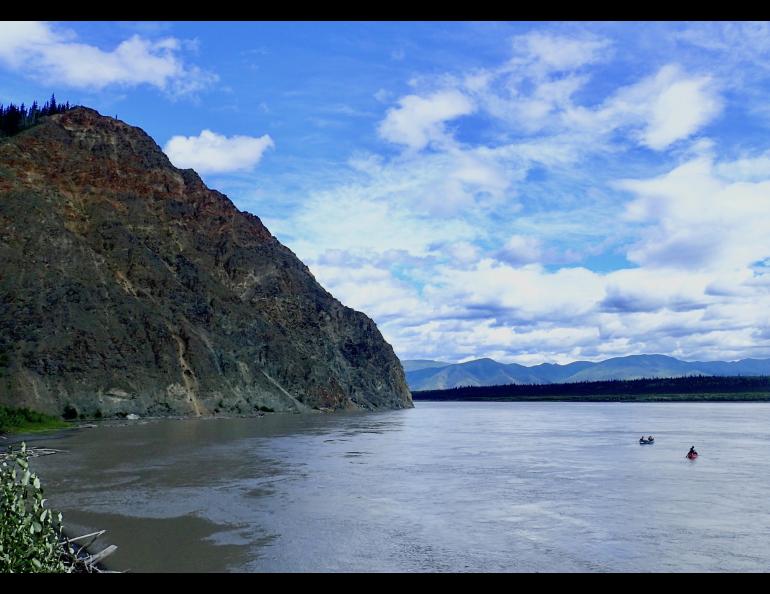 Two canoes float past Eagle in July, 2018. Photo by Ned Rozell.
