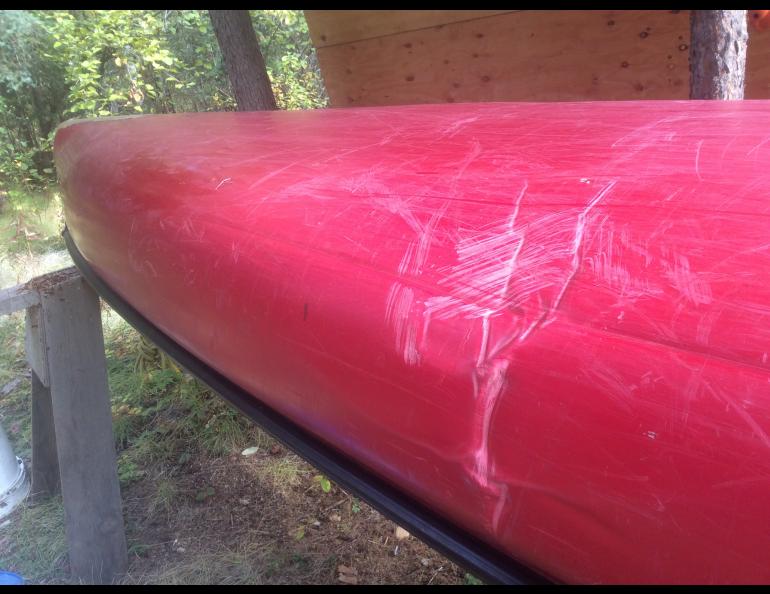 The creased hull of the canoe that a river folded over a rock. Photo by Ned Rozell.