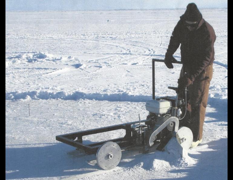 Lew Shapiro cuts into sea ice north of Utqiaġvik, then called Barrow, during his long career with the Geophysical Institute. Photo courtesy of UAF Geophysical Institute.