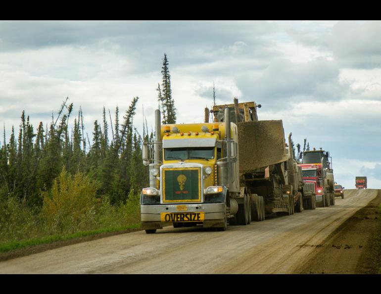 Semi trucks on a dirt road
