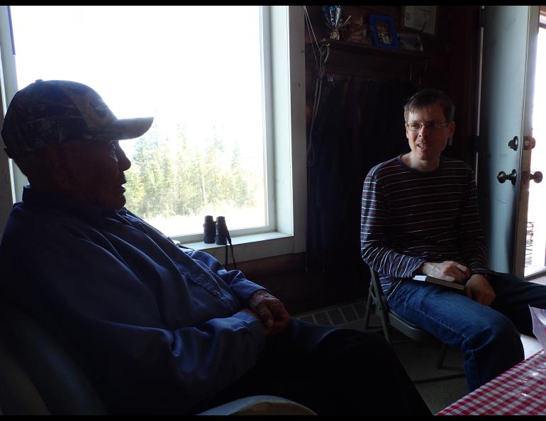 In Minto, Alaska, UAF seismologist Carl Tape listens to the late Berkman Silas in 2014. Silas remembered a large earthquake he experienced in 1937. Photo by Ned Rozell.