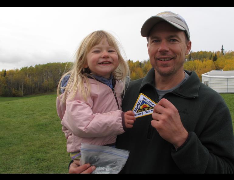 Three-year-old Anna Rozell celebrates her finish of the 2009 Equinox Marathon with her father Ned Rozell. Photo courtesy Ned Rozell.