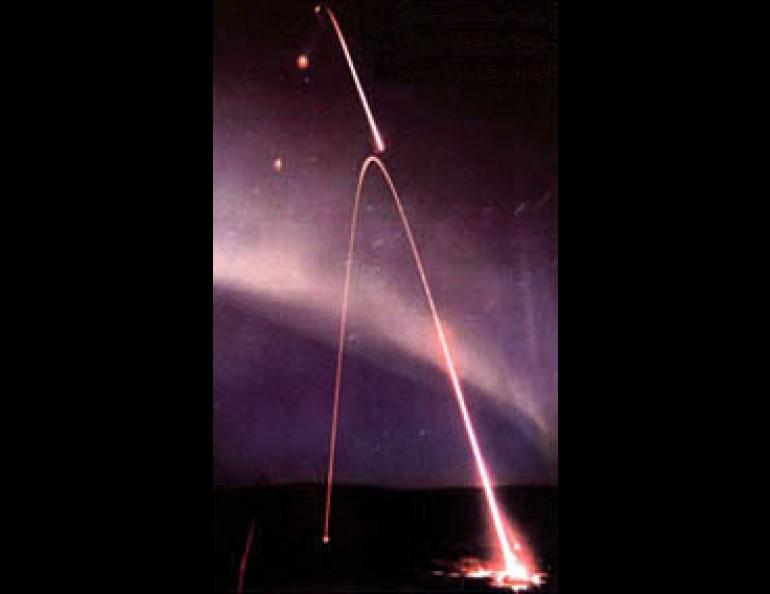With an intense auroral display in the background, a three-stage Black Brant sounding rocket is launched from the Poker Flat rocket range near Fairbanks. (Photo by Randall Sluder and Gregory Boquist of Technology International Corp.)