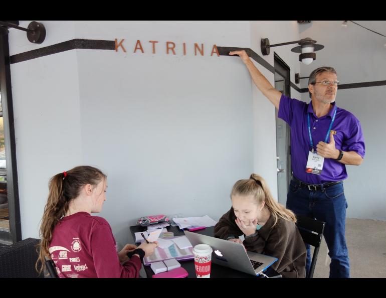 At a New Orleans coffee shop, Louisiana state climatologist Barry Keim shows reporters the level of floodwaters from Hurricane Katrina in 2005.