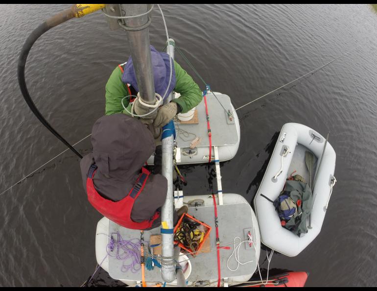 From above, Chris Maio (in green) and graduate student Reyce Bogardus pull a sediment core from a lake near Cape Espenberg. Chris Maio photo.