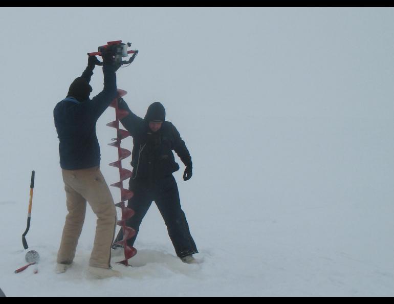 Guido Grosse and Benjamin Jones drill a hole through the ice of Teshekpuk Lake on a recent mission to learn more about lakes in the Arctic. Photo by Chris Arp.