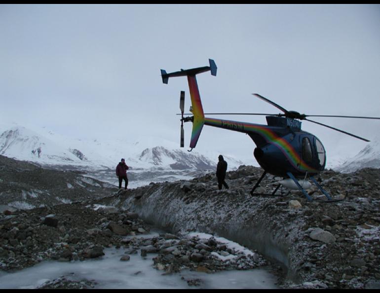 USGS geologist Peter Haeussler uses a satellite phone to tell a seismologist about the discovery of the Susitna Glacier fault on Nov. 10, 2002. Photos courtesy of Peter Haeussler, U.S. Geological Survey
