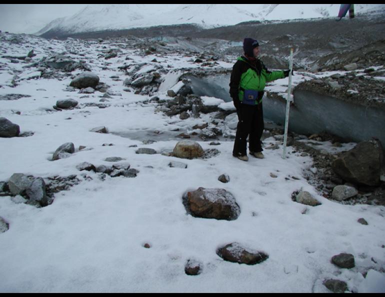  Patty Craw, a geologist with the Alaska Division of Geological &amp; Geophysical Surveys in Fairbanks, stands in front of the Susitna Glacier thrust fault. Photos courtesy of Peter Haeussler, U.S. Geological Survey 