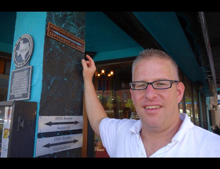 Hal Needham of the Galveston Historical Foundation shows the downtown water mark from Hurricane Ike’s storm surge in 2008. Ned Rozell photo.