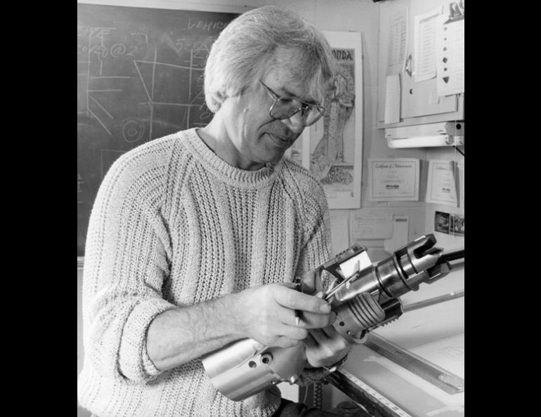  Larry Kozycki holds part of the drill he developed to penetrate the Greenland ice cap. Photo by Evelyn Trabant. 