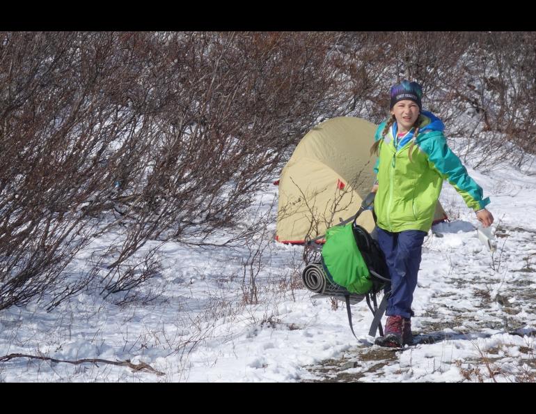 Anna Rozell exits the tent near Phelan Creek while joining her parents for nine days of hiking the path of the Trans-Alaska Pipeline. Photo by Ned Rozell