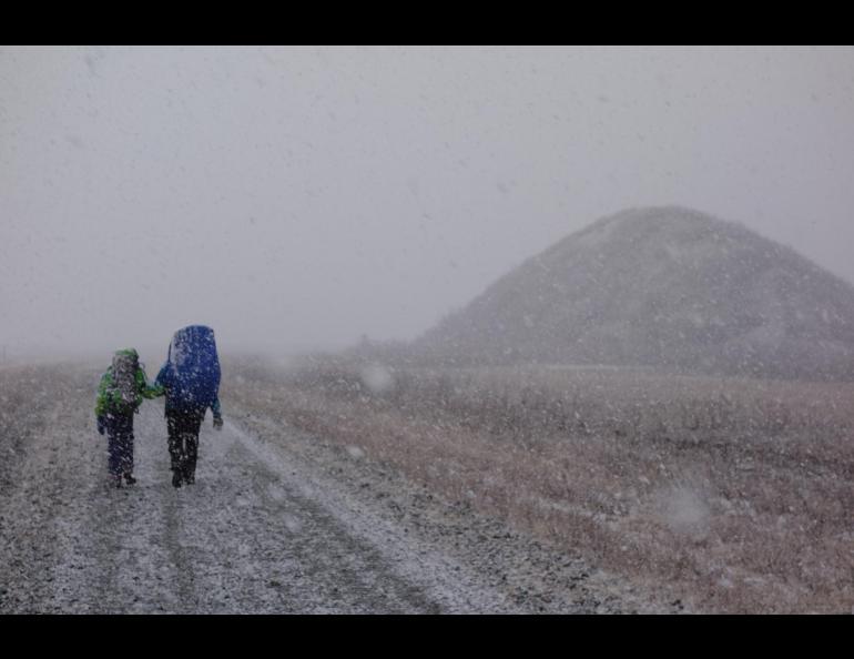 Anna and Kristen Rozell hike through a snowstorm in Isabel Pass. Photo by Ned Rozell