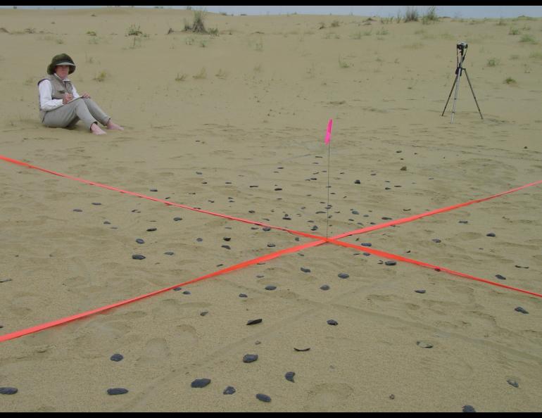 U.S. Fish and Wildlife Service biologist Karin Bodony at the site of an obsidian tool discovery in the Nogahabara Dunes in 2002. Photo by Dan Odess.