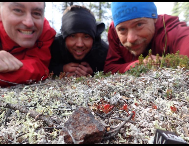 From left, Peter Jenniskens, Garrett Jones and Ned Rozell pose by an unusual rock they found near the Middle Fork of the Chandalar River. Photo by Ned Rozell.