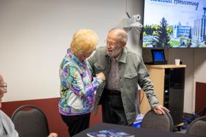 Jeanne Hume (left) greets Chuck Deehr at the 2026 GI reunion. Photo by Eric Marshall