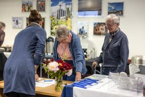 Sara Wilbur (left) welcomes Nancy and Tom Hallinan to the 2026 GI reunion. Photo by Tucker Forbes