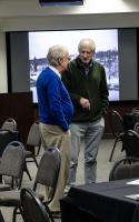 Hans Nielsen (left) and Brenton Watkins in deep discussion during the 2026 GI reunion. Photo by Tucker Forbes