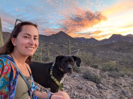 Veleda A. Paiva Muller joined UAF as a joint GI/CNSM appointment in May 2026. Goose and she are shown hanging out in the Sonoran Desert in Arizona on a gorgeous sky day.