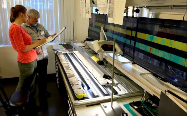 Elise Chenot, of the Université de Bourgogne-Franche Comté, left, and Michael Whalen, of the UAF Geophysical Institute, examine a rock core from the Chicxulub crater in a lab in Bremen, Germany. Photo by Kevin Kurtz.