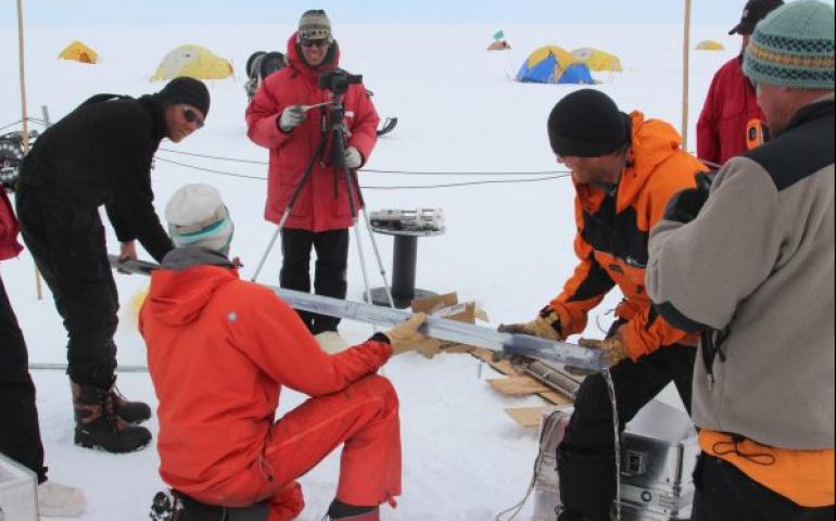Martin Truffer of UAF’s GI, left, holds a core tube which has brought up a sample of sediment from the sea floor below Pine Island Glacier. Photo by Dale Pomraning.