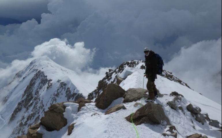 Rhett Foster from CompassData pauses on a ridge leading to the 17,000 foot base camp. Photo by Tom Heinrichs, UAF Geophysical Institute.