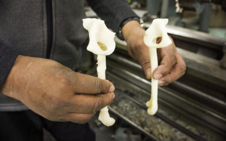 Greg Shipman of the Geophysical Institute holds 3-D printed, one-third scale models of the broken (left) and unbroken femurs of a 12-year-old boy. The GI Machine Shop made the models for Fairbanks Memorial Hospital. Geophysical Institute photo by LJ Evans.