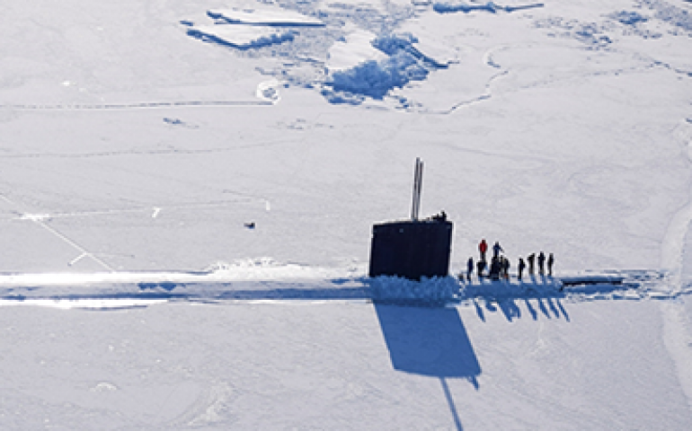 A submarine surfaces through the Arctic Ocean sea ice during a previous naval Ice Exercise. Photo courtesy of Arctic Submarine Lab