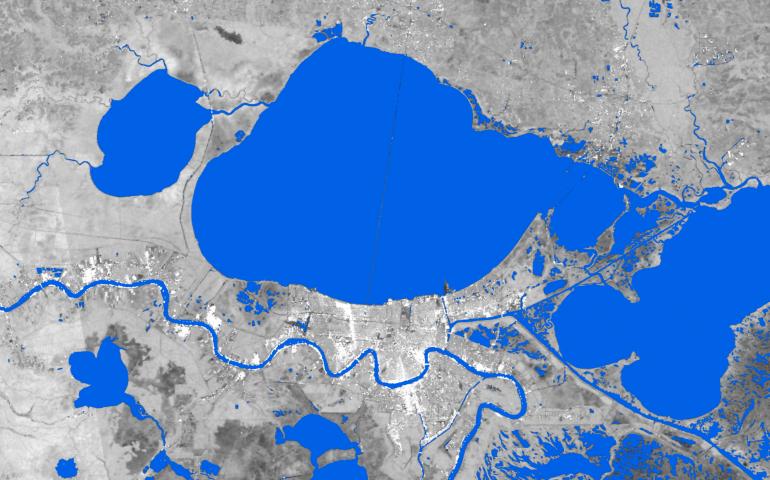 Surface water extent is shown (blue) around New Orleans on Aug 29, 2021. Water extent data is derived from synthetic aperture radar. A SAR image is in the background. Credit: UAF Geophysical Institute.