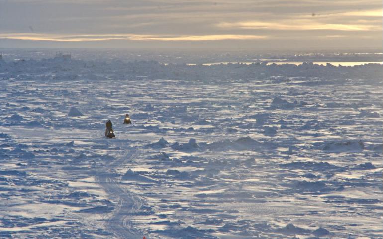 Residents of Utqiagvik return by snowmachine from the lead at the edge of the shore-fast ice. Photo by Andy Mahoney, UAF Geophysical Institute