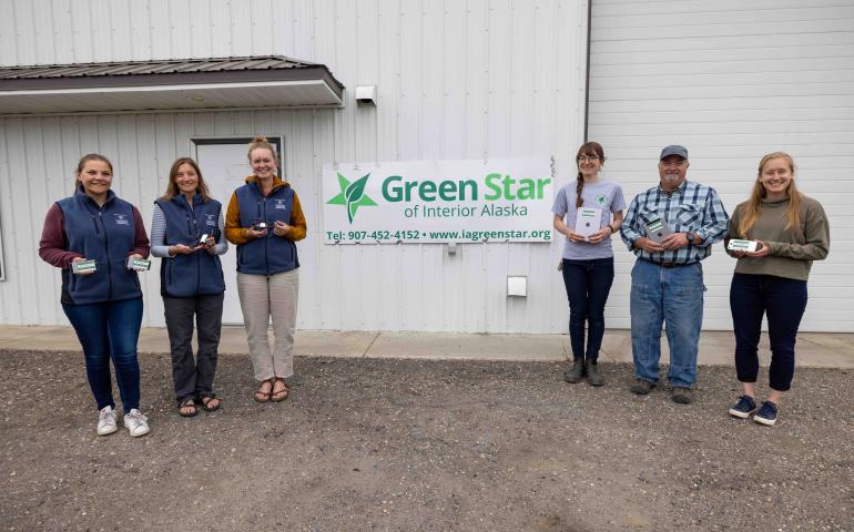 From left, Marine Vanlandeghem Gillespie, Kalee Meurlott and Mariah McNamara, all of the UAF Geophysical Institute, hold recycled equipment along with Cherissa Dukelow, Art Gelvin and Kenzley Defler, of Green Star of Interior Alaska, at the Green Star facility in Fairbanks. Photo by Daniel Walker
