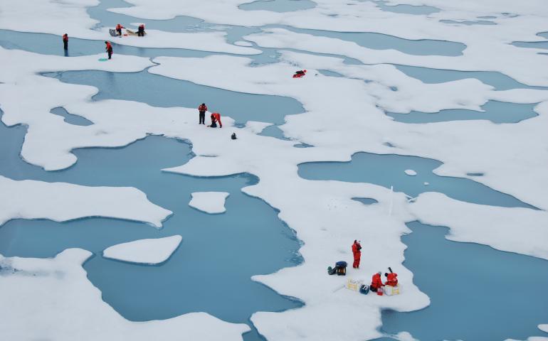 Scientists on the MOSAiC expedition work among Arctic melt ponds in 2020. Photo by Melinda Webster