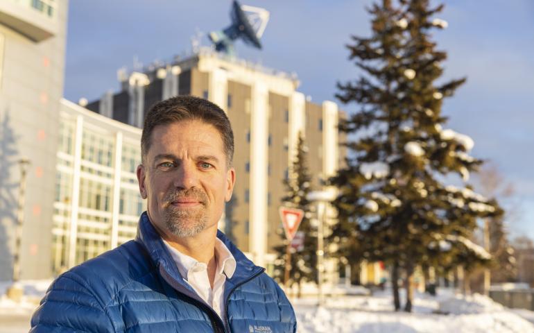 Alaska Satellite Facility Director Wade Albright, with the Elvey Building behind him at the University of Alaska Fairbanks. ASF is located in the Elvey Building. Photo by JR Ancheta
